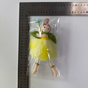 Close-up of yellow flower fairy doll showing multilayer mesh skirt and size measurement