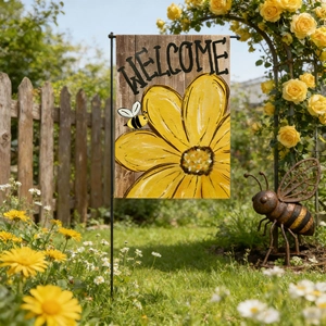 Bee Gnome Sunflower Welcome Garden Flag with black metal stand in a sunny garden setting