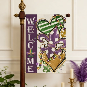 Detail of Mardi Gras garden flag with Welcome text, hanging on a mahogany pole against a wall