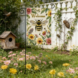 Linen garden flag with bee and flowers pattern hanging on a black metal bracket