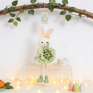 Detailed view of Easter bunny angel ornament with green fabric flower and woven rope legs