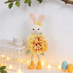 Detail of Easter bunny pendant with large yellow flower on a festive tree branch