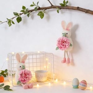 Detailed view of plush Easter bunny ornaments with pink flowers and mesh basket decor