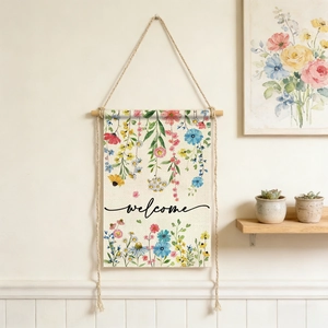 Close-up of linen garden flag with floral pattern and welcome text on a wall