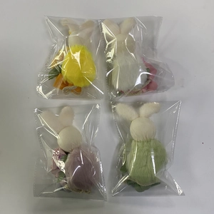 Close-up of colorful plush Easter bunny hanging ornaments in individual plastic packaging