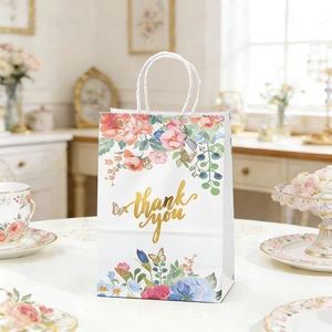 Detailed close-up of floral paper gift bag with golden Thank You text and rope handle