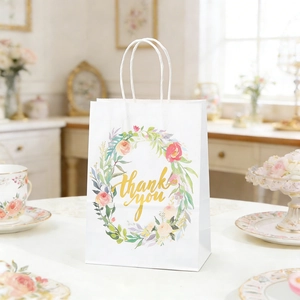 Vertical floral gift bag with Thank You gold print and white woven rope handles