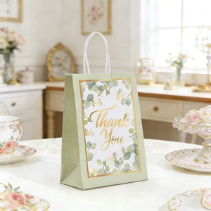 Detail of floral gift bag with sage green finish and gold Thank You lettering