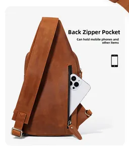 Macro detail of the back zipper pocket on brown leather chest bag showing phone storage