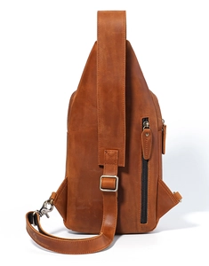 Close-up of premium brown leather chest bag with vertical zipper and textured cowhide finish