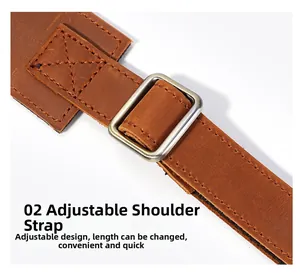 Detailed view of adjustable brown leather shoulder strap with silver metal buckle and stitching
