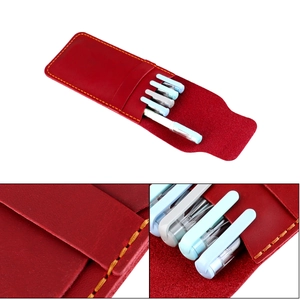 Macro shot of red crazy horse leather pen case showing fine texture and yellow stitching