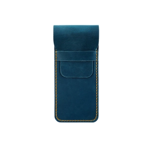 Detail of crazy horse leather pen case with yellow contrast stitching and buckle strap