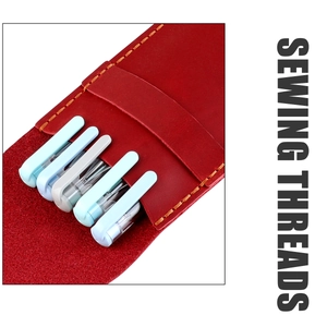 Close-up of vintage deep red leather pen holder with detailed orange stitching craftsmanship