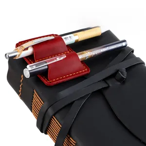 Macro view of burgundy crazy horse leather dual pen holder with hand-stitched details