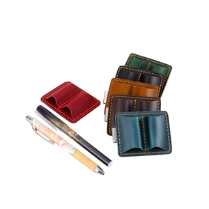 Detailed view of genuine leather double pen case featuring metal clip and contrast stitching