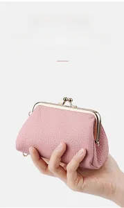 Pink lychee grain leather coin purse with classic golden kiss-lock closure detail
