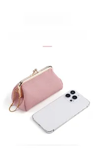 Pink lychee texture leather coin purse size comparison next to a smartphone