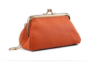 Detail of orange lychee grain leather coin purse with vintage gold clasp and chain