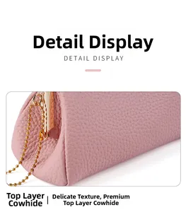 Macro shot of pink genuine leather coin purse showing fine litchi grain and gold chain