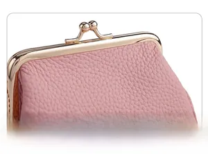Detailed shot of pink pebble grain leather coin purse with golden metal clasp