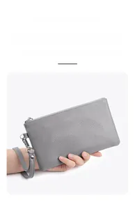 Gray lychee grain leather wristlet clutch featuring a functional detachable lanyard strap