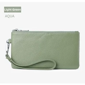 Macro shot of aqua green pebbled leather wristlet with silver zipper and wrist strap