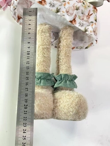 Detail view of telescopic plush rabbit legs showing 21cm length measurement with ruler