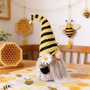Knitted bee festival gnome with striped hat and daisy decor on a honey-themed table