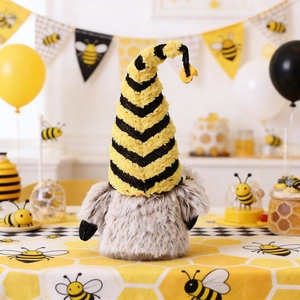 Macro detail of knitted bee festival gnome plush with yellow and black striped hat