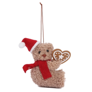 Brown curly plush teddy bear with red Christmas hat and gingerbread heart hanging decoration