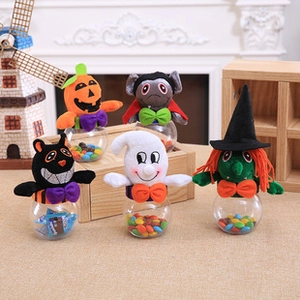 Detail of Halloween candy jars featuring plush pumpkin, ghost, and bat characters