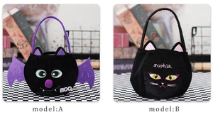 Detail view of plush Halloween candy bags featuring black bat and cat designs