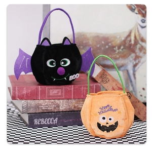 Detail of plush Halloween candy bags featuring bat and pumpkin designs with embroidery