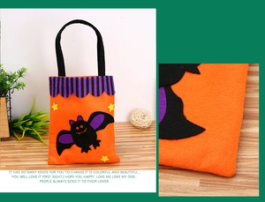 Detail of Halloween felt candy bag featuring a black bat patch and orange star accents