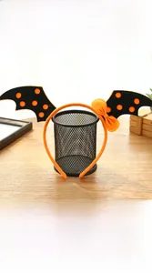 Close-up of Halloween bat wing headband with orange polka dots and decorative bow detail