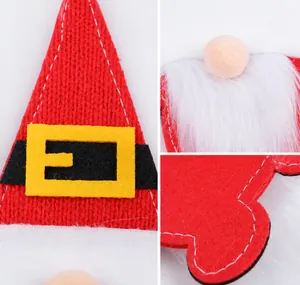 Detail view of red knitted Christmas gnome cutlery holder with belt and plush beard