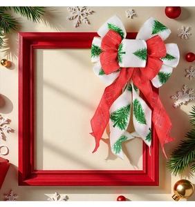 Detail of red and white Christmas bow with green tree pattern on a wooden frame