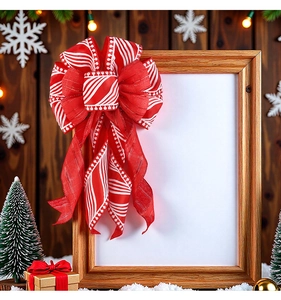 Detail of red and white striped Christmas bow with snowflakes on a festive background