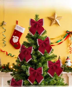Close-up of a burgundy velvet Christmas bow with glitter edges on a festive background