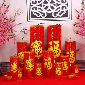 Detail of red hollow Chinese New Year firecracker ornaments with gold Fu character symbols