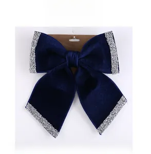 Macro shot of large dark blue velvet bow hair clip with sparkling silver sequins