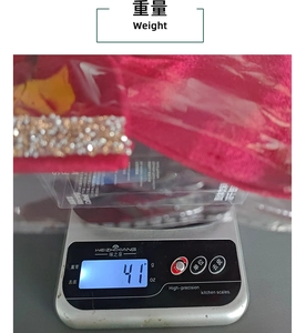 Detailed view showing the weight measurement of a red glitter Christmas bow at 41g