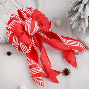 Red and white striped Christmas bow with velvet texture for holiday tree decoration