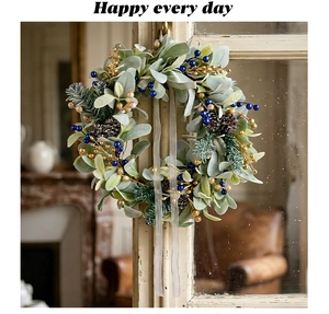 Detail of Christmas wreath with lamb ear leaves, pine cones and blue berries on window