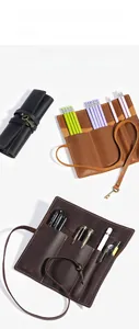Detailed view of leather roll pencil cases with vintage key closure in three colors