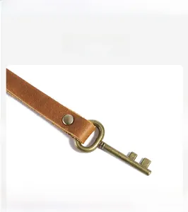 Close-up of premium brown cowhide leather roll and vintage bronze metal buckle detail