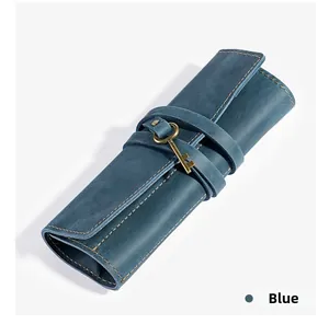 Detail of blue leather roll-up pencil case with contrast stitching and key charm