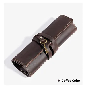 Detail of coffee genuine leather pencil roll with vintage key charm and stitching