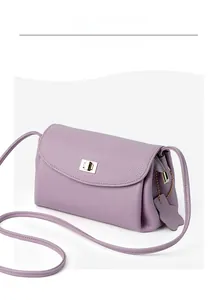 Detailed view of lilac lychee grain leather crossbody bag with square metal buckle lock